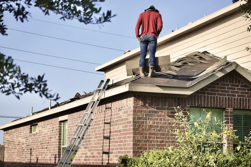Professional roofer working on a residential roof in Cherokee Woods